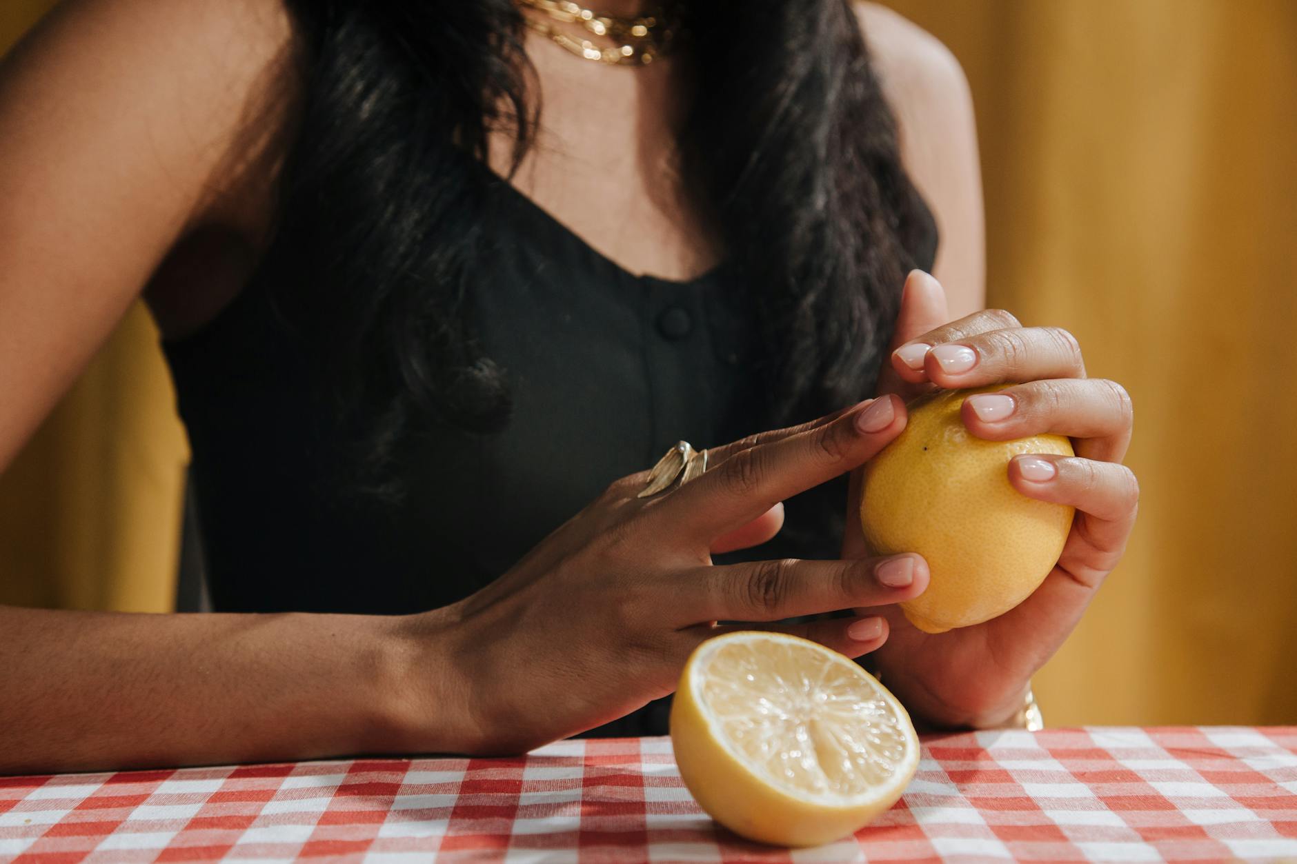 Blue lemon vibrator surrounded by flowers and citrus slices on a yellow background
