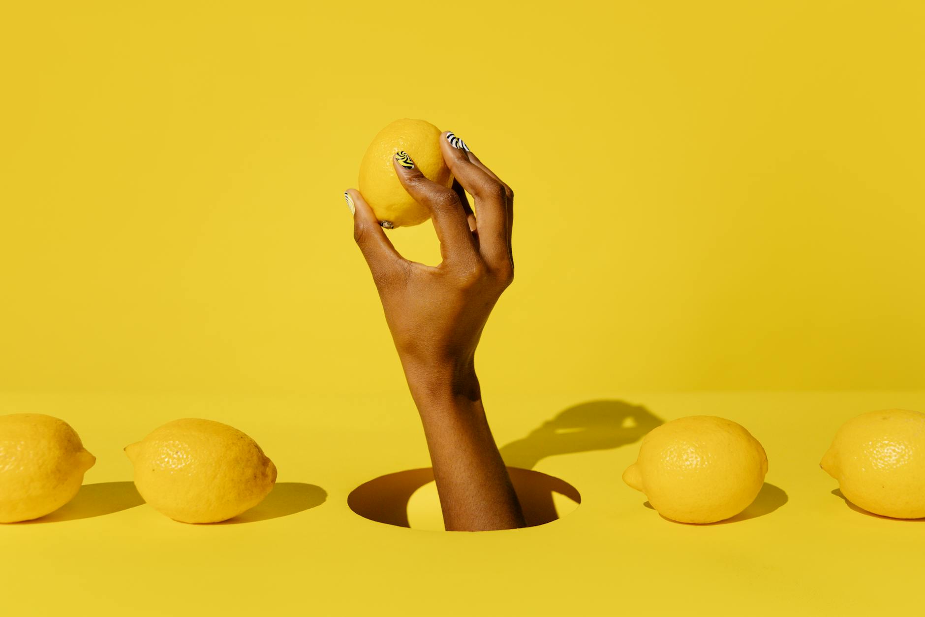 Two hands holding vibrators against a pastel background, representing shared intimacy and partnership