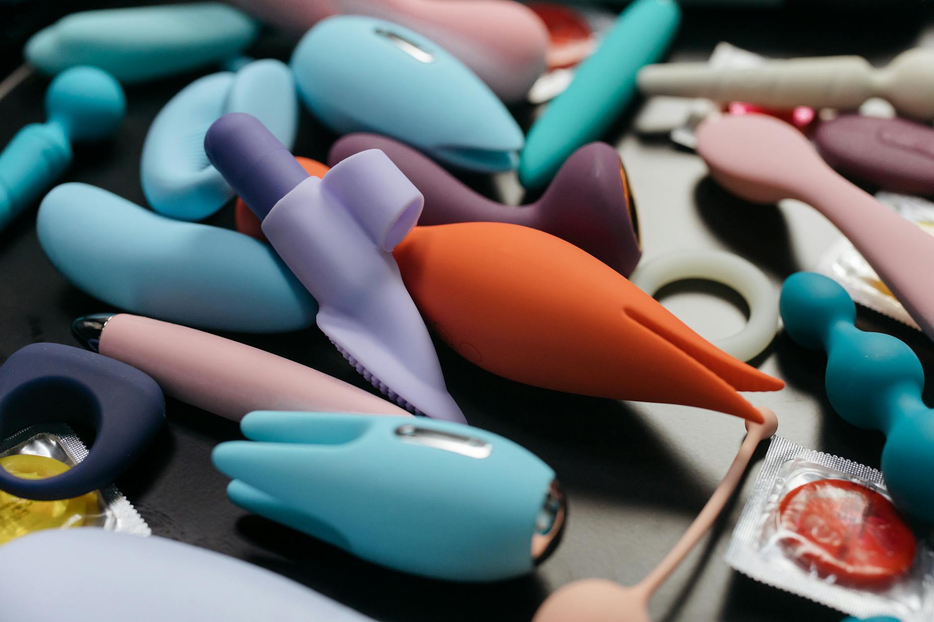 An array of vibrant lemon clitoral vibrators and adult toys in close-up