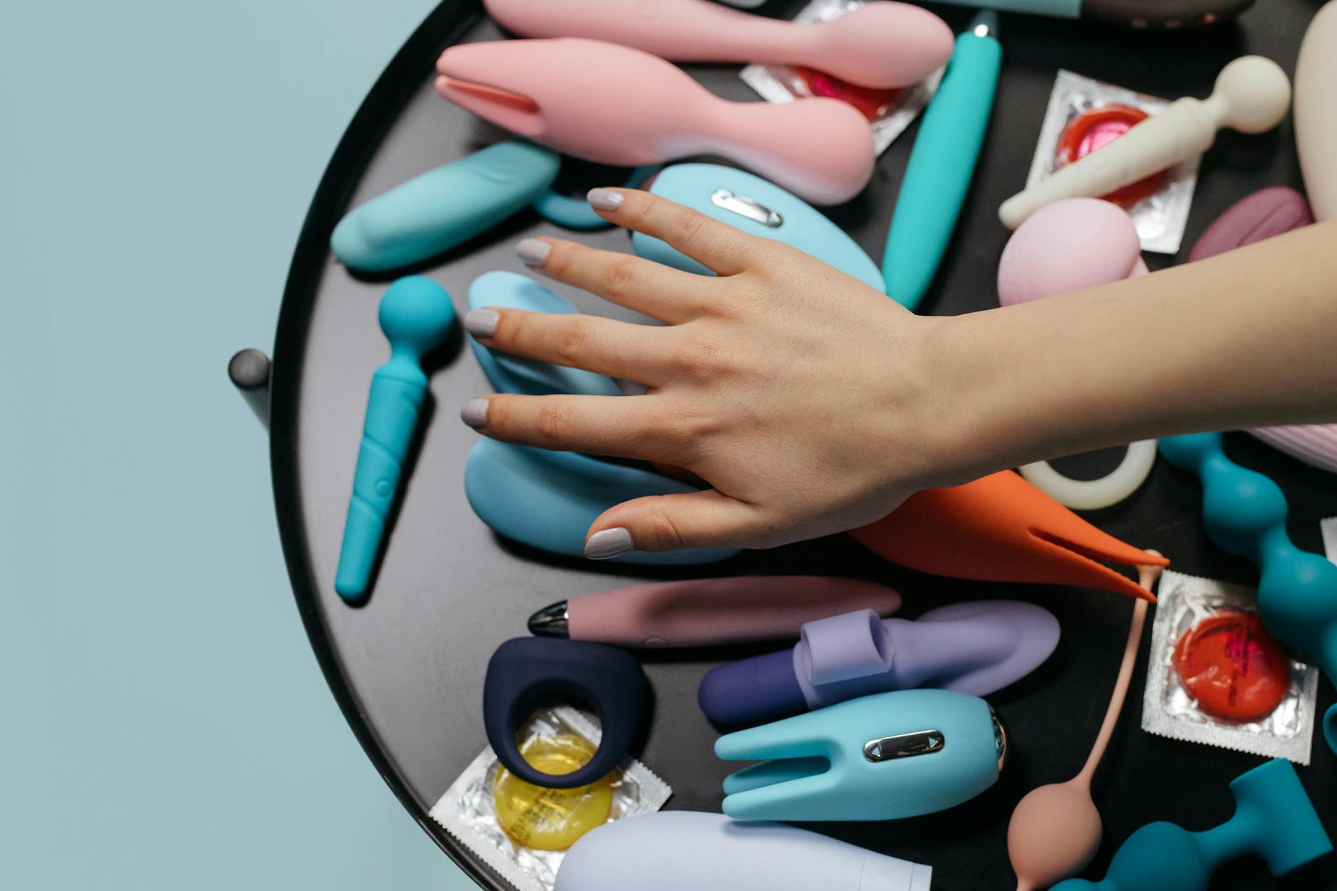 Hand holding a vibrator, symbolizing solo pleasure and self-care during relationship strain